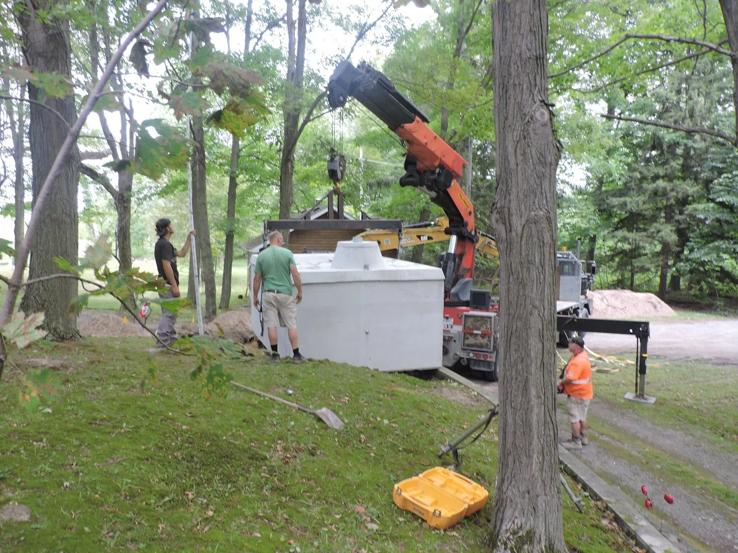 After many very slow adjustments the roughly 8x15x6 ft 3000 gallon cistern was lowered into place.