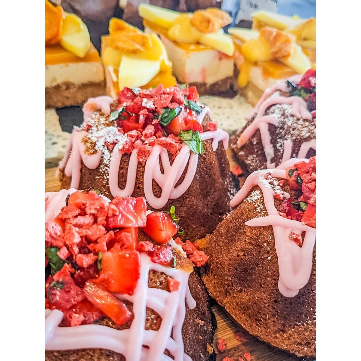 Forget the weather, sunshine is a state of mind with our Strawberry &amp; Basil Bundts and Mango, Passionfruit &amp; Papaya Cheesecake Shortbread 🌞🌻🍊🍋💛