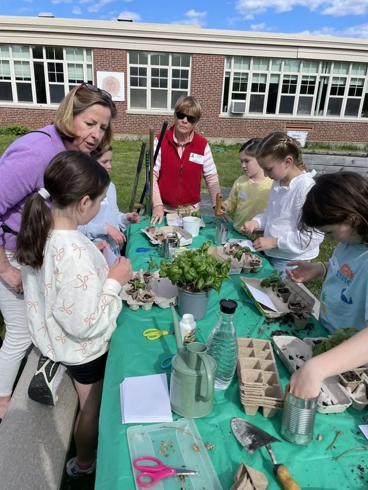 49-club-members-helping-students-pot-up-basil-a.jpg