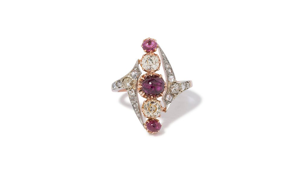    Navette shaped ruby &amp; old mine cut diamond ring set in platinum and 14k rose gold.   The origin of the French word "navette" dates to the early 1900's and translates to “little ship," as the style mimics a boat.   