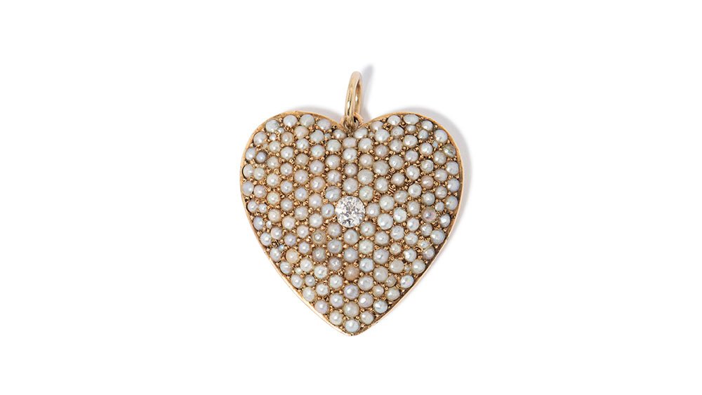    Heart shapped Locket with natural pearls and one diamond set in 14k yellow gold.   