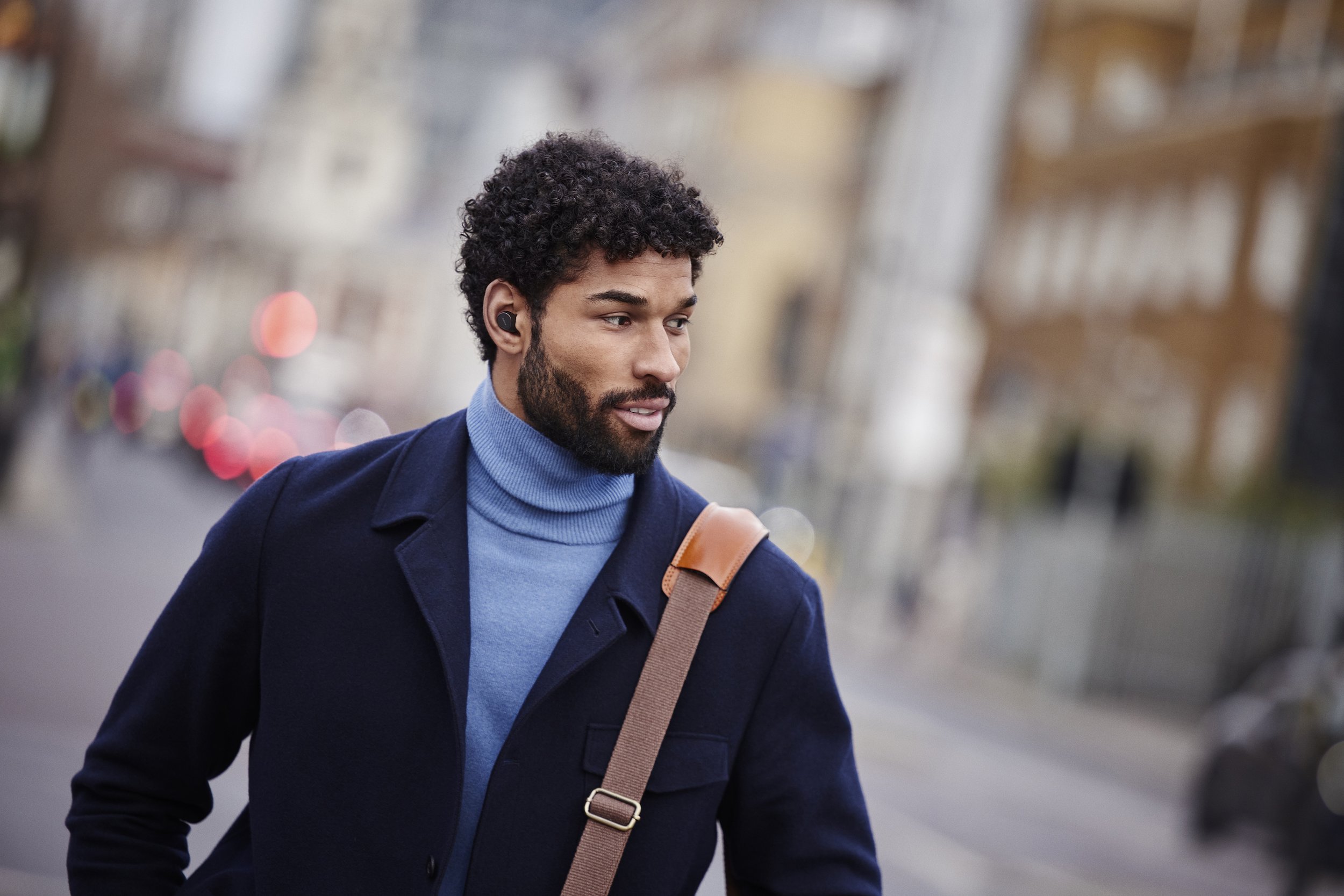Jabra Evolve2 Buds male street walking Medium.jpg