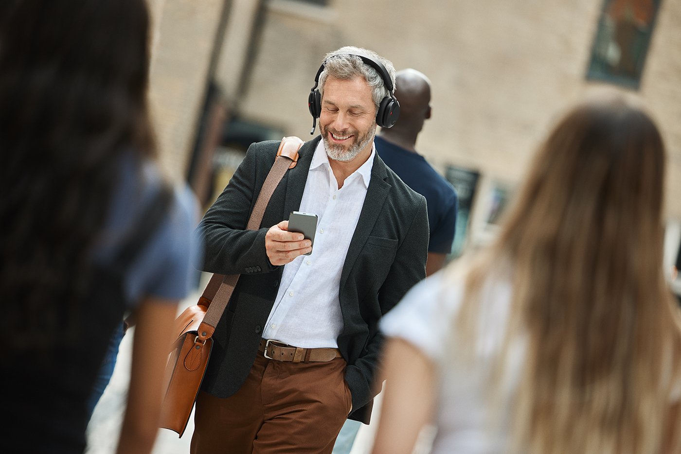Jabra Evolve2 75 Lifestyle Male Street Walking Phone Amazon.jpg