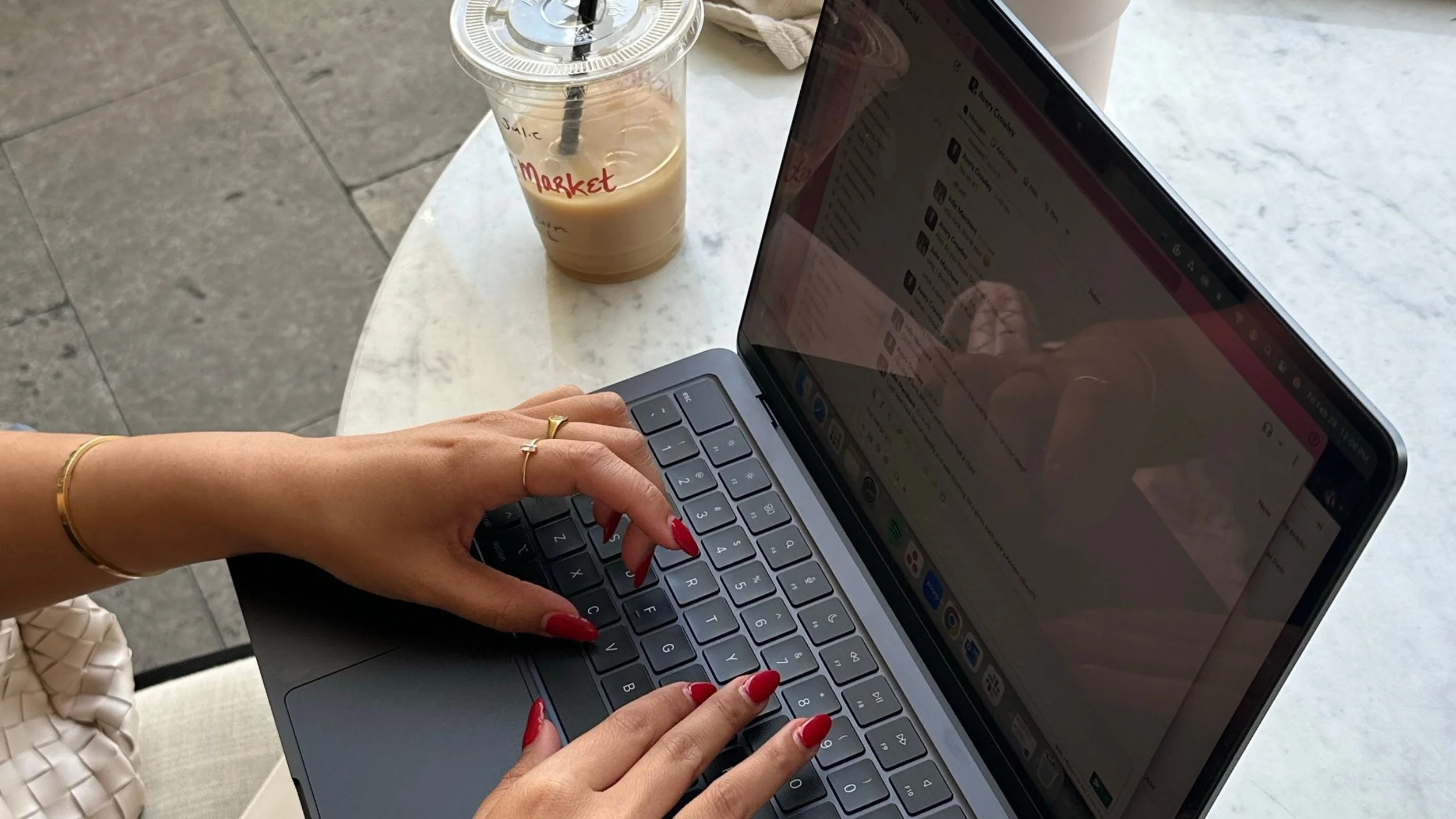 Business owner researching their ideal client while working on a laptop in a coffee shop