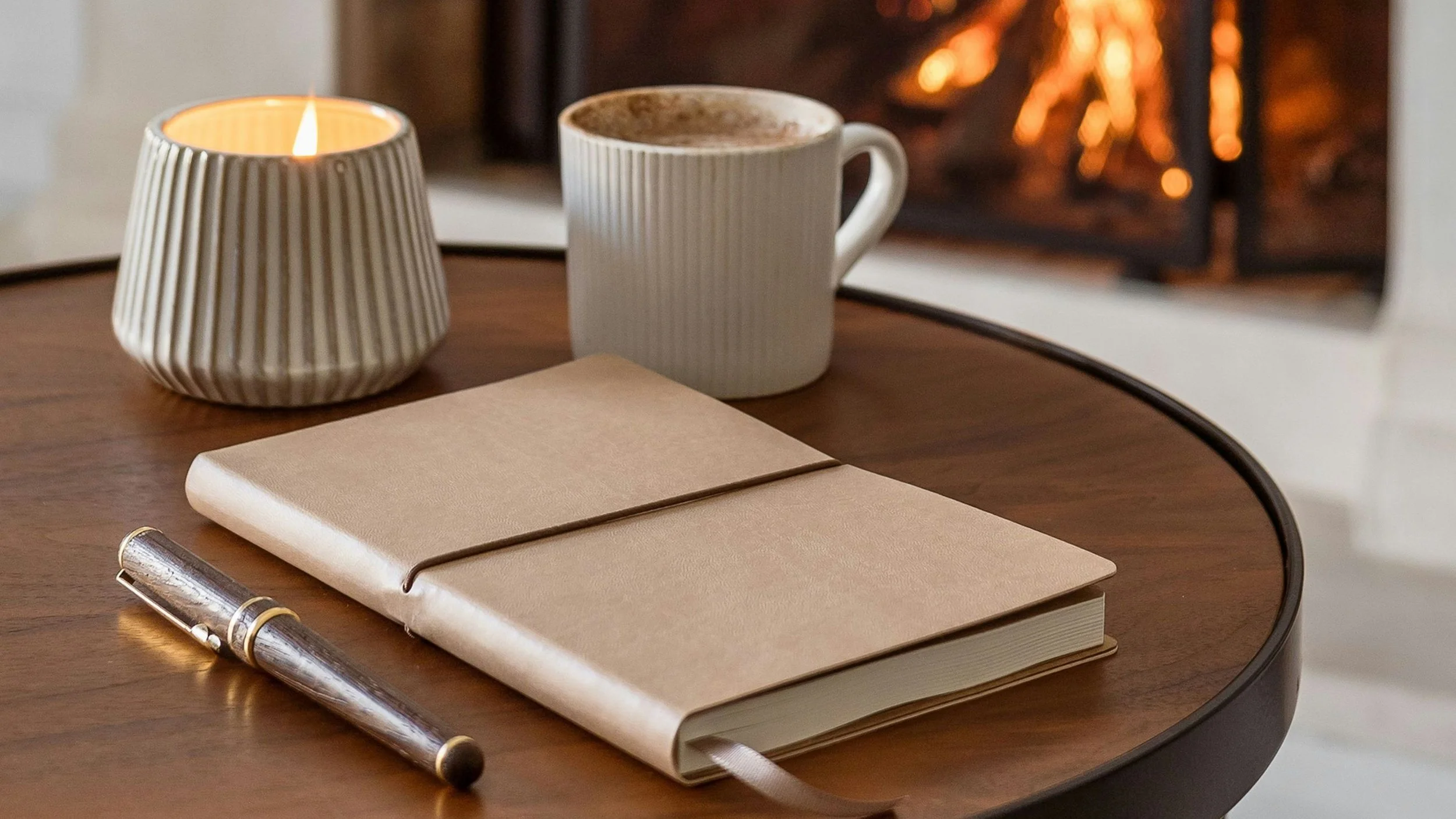 Notebook and coffee by a fireplace used for thoughtful brand clarity and planning