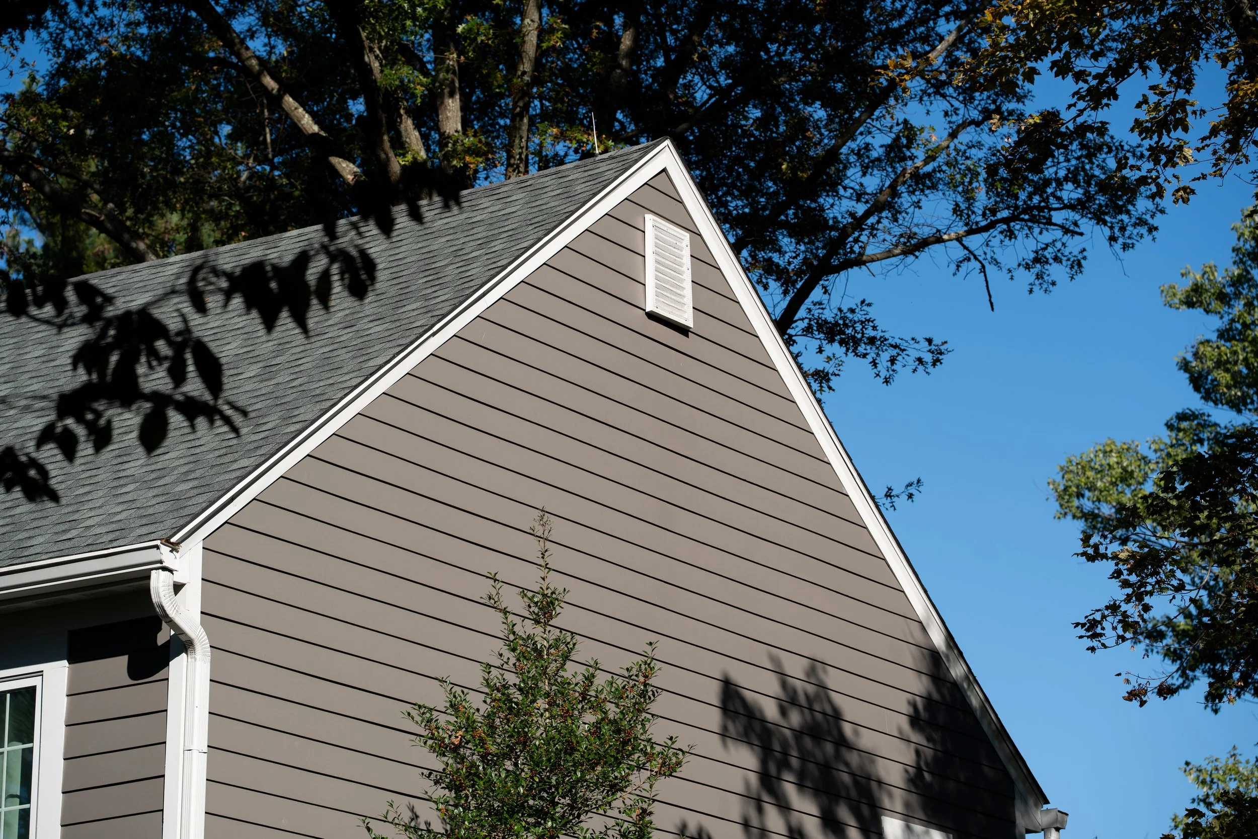 Close-up of mildew stains being scrubbed off house siding
