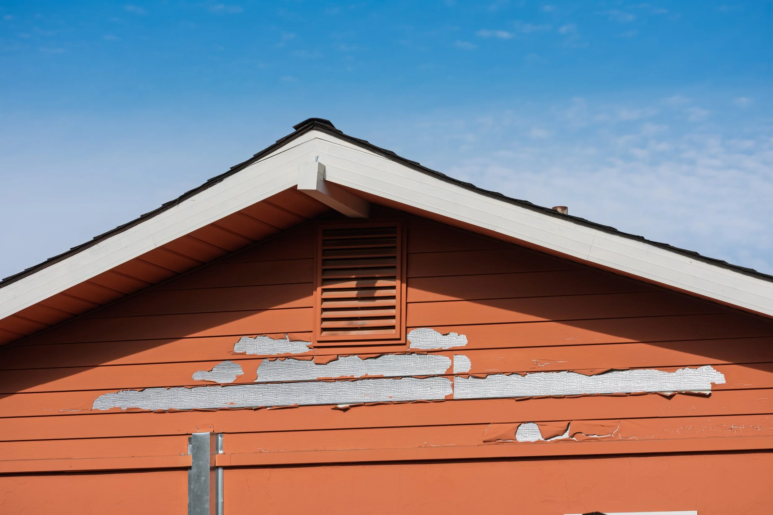 Warped and buckling siding panels on a Louisville home showing signs of moisture damage