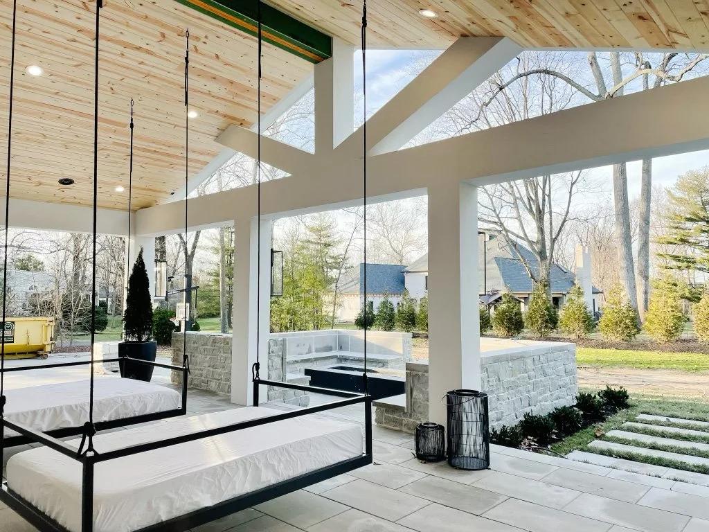 Modern covered porch with white columns and outdoor seating in Louisville KY