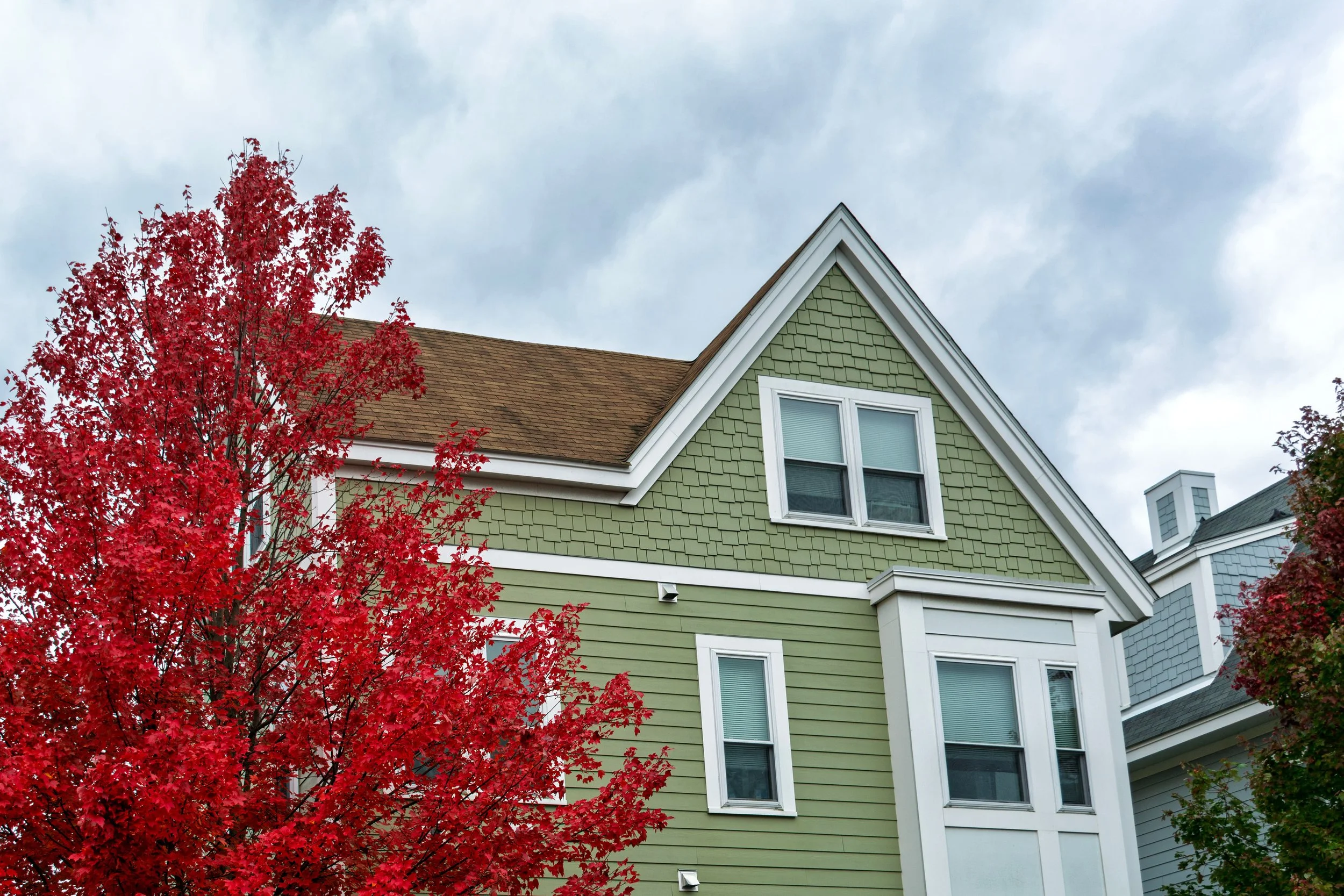 green fiber cement siding on 3 bedroom house.