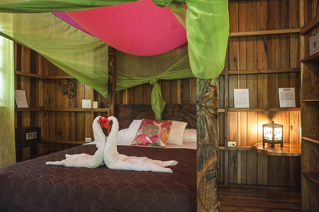 Bed with two towel birds forming a heart shape