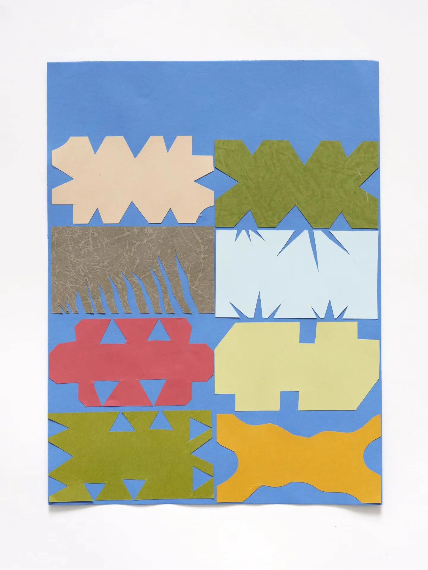 "Flower&rdquo; by Annie Rose Macer

#cutpapercollage 

ID: On a blue paper background there are eight cut paper shapes in varying shapes and colors. The shapes are aligned in an edge to edge 2 x 4 grid starting at the bottom edge of the paper, e