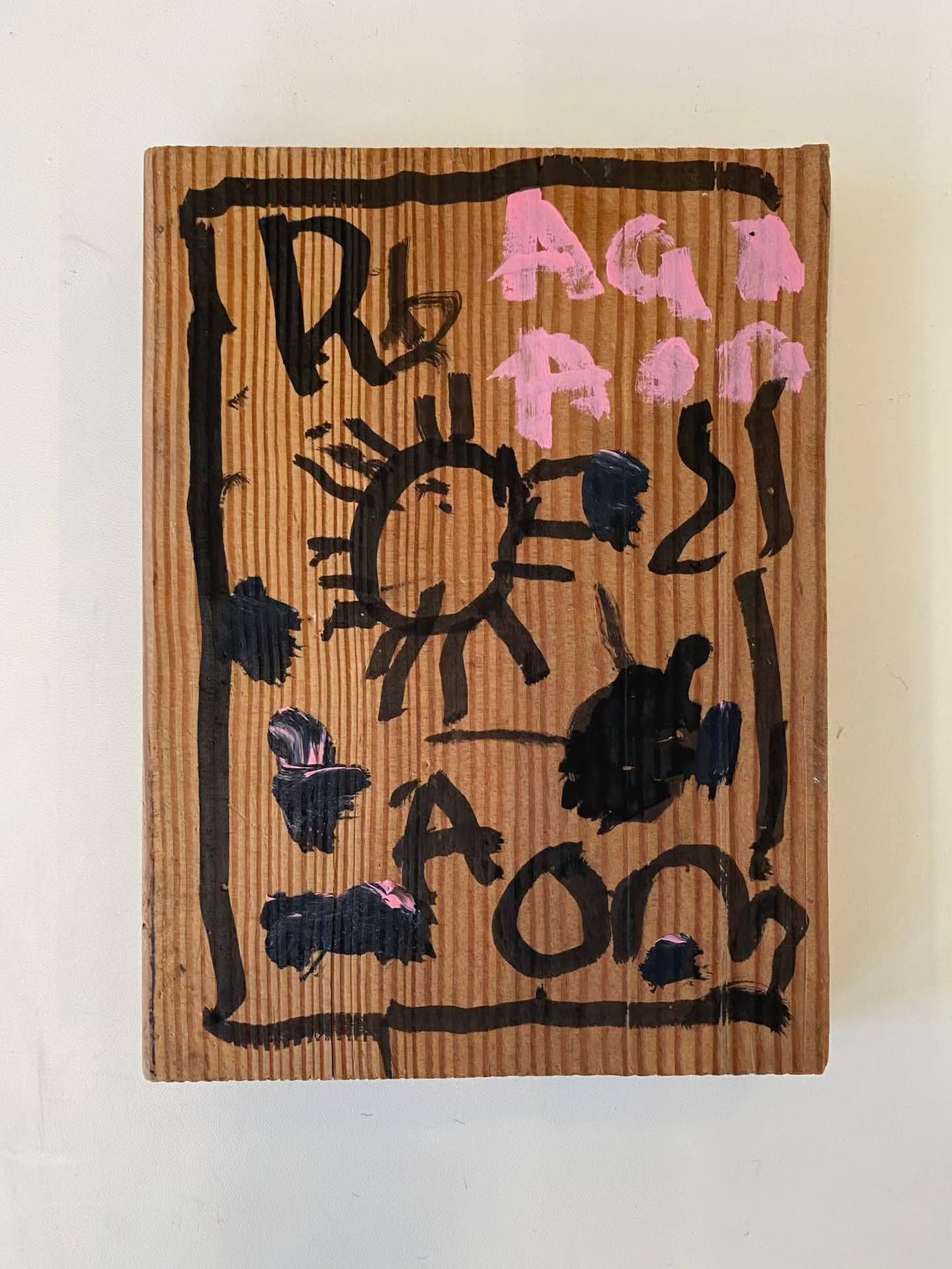 Take a look at this piece by artist Adam Richards! We love the contrast between the texture of the acrylic paint and the wood, what do you think?

ID: Painted on a wood panel visible are various letter forms, and symbols painted in black and pink tha