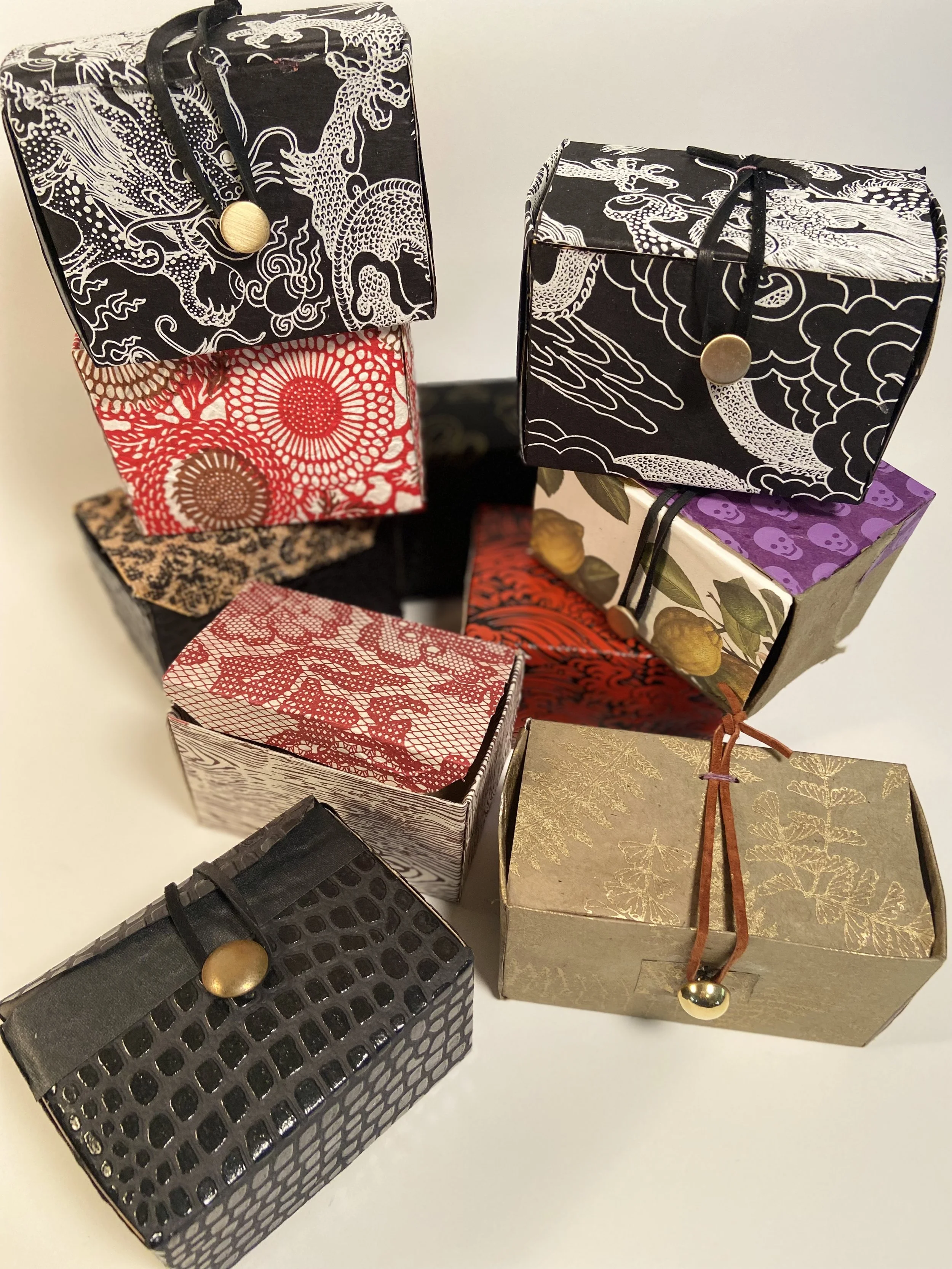 MAGIC BOXES
up cycled tea boxes made new with handmade papers, metal buttons, leather closures.