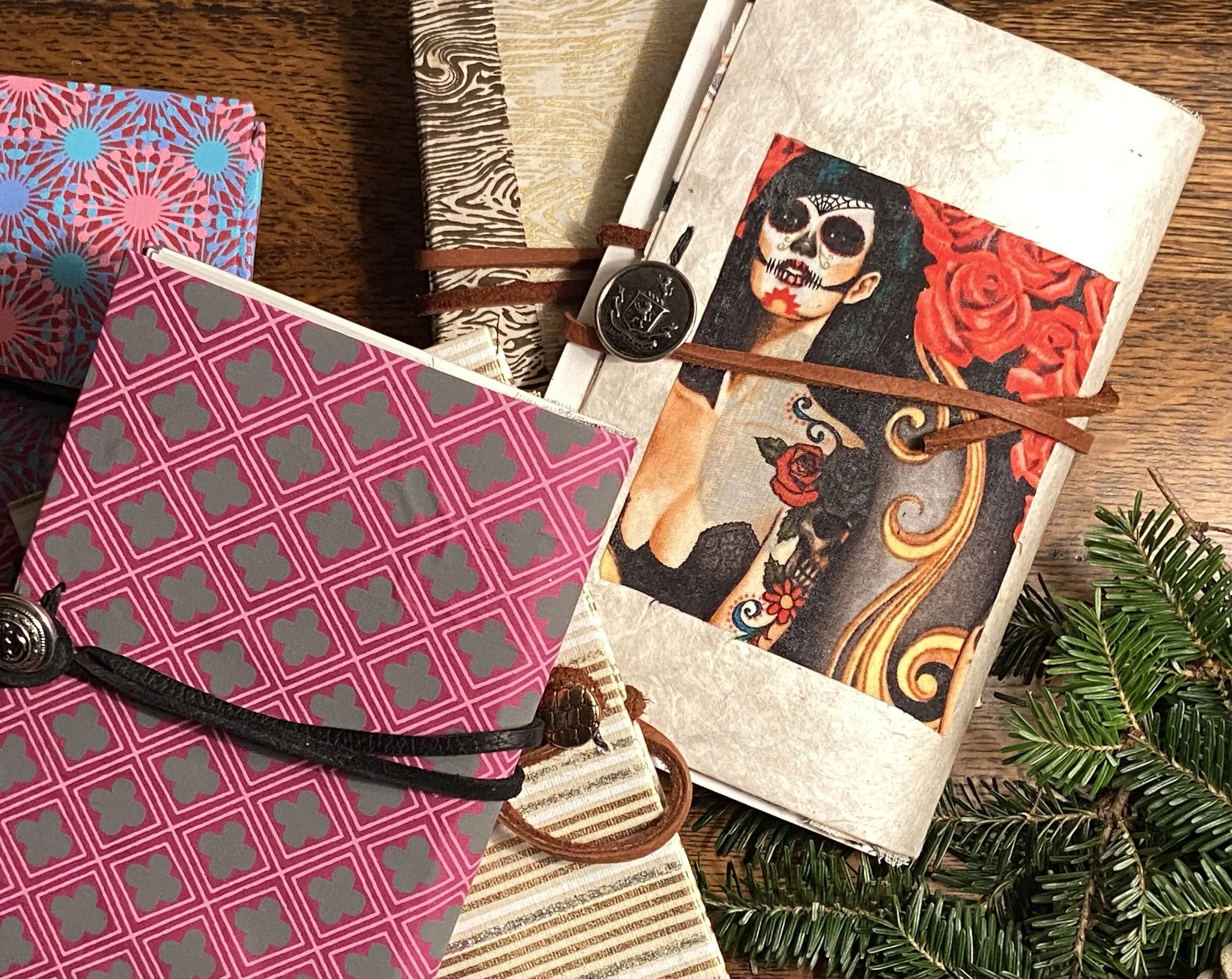 Slim journals with metal buttons and leather closures