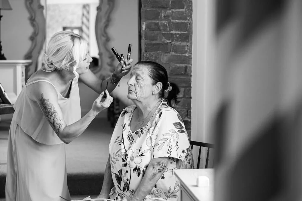 brides mum having makeup done