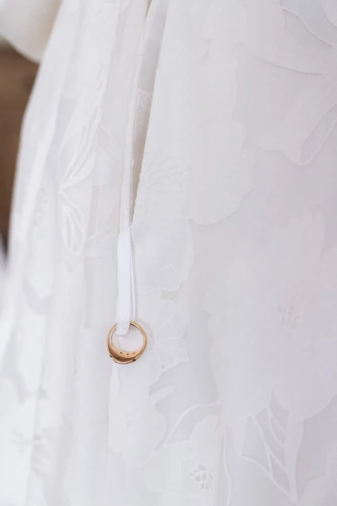 grandparents ring attached to wedding dress for significance