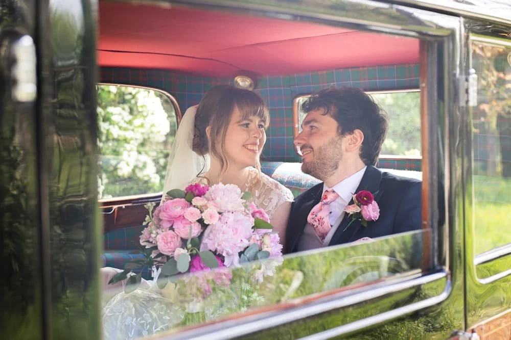 bride and groom in wedding car