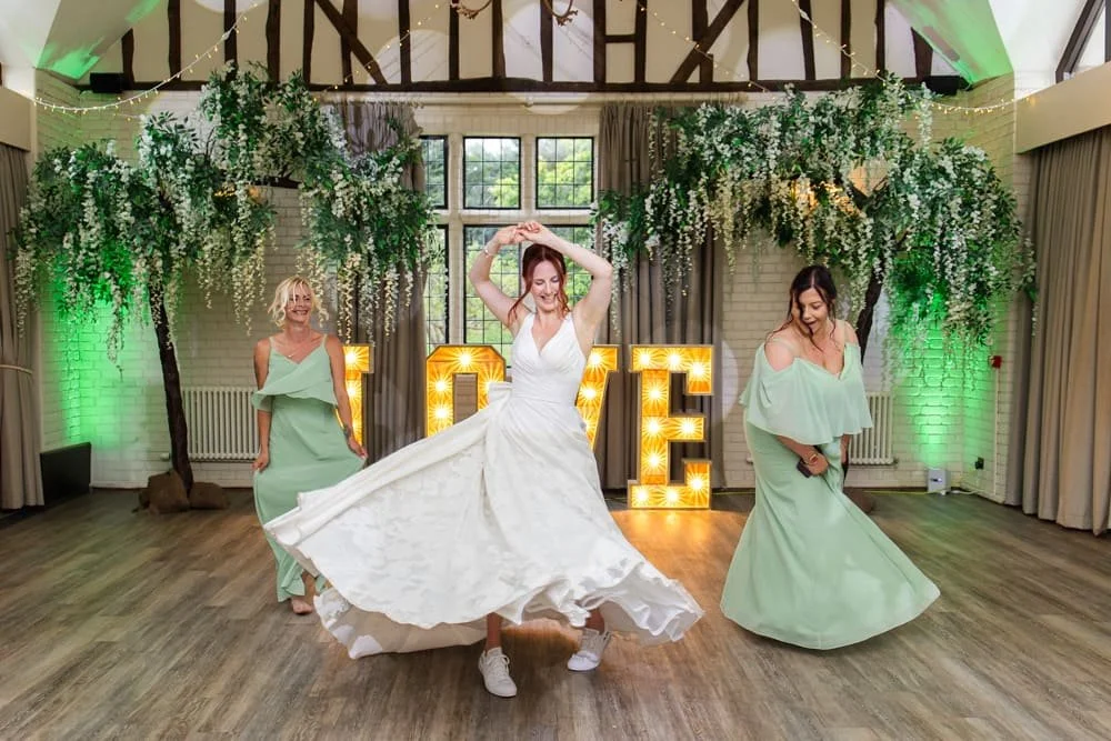 bride dancing with bridesmaids