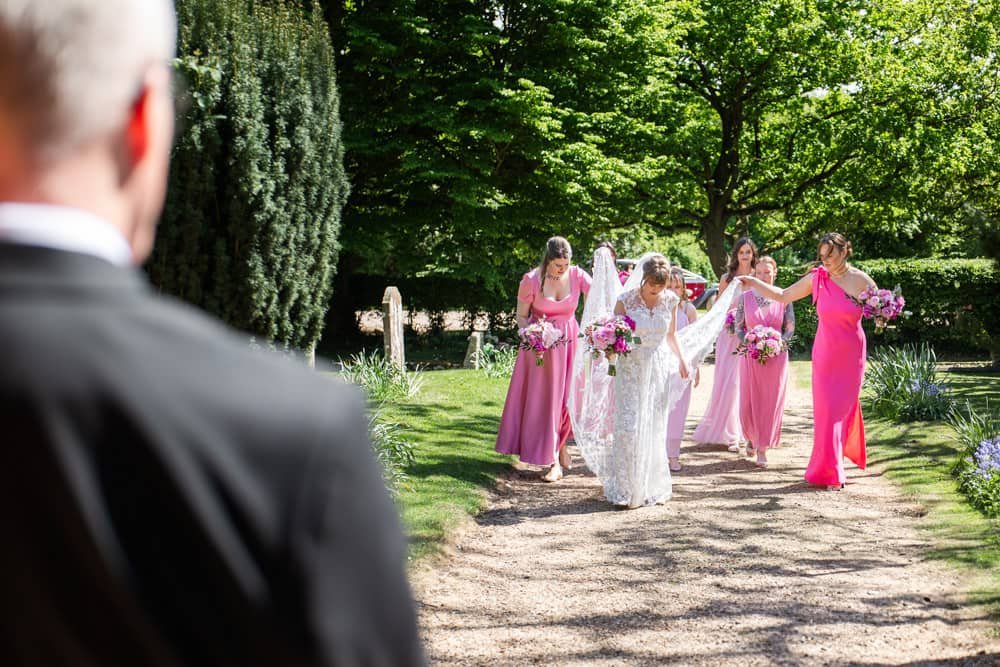 Bride and her bridesmaids walking towards church