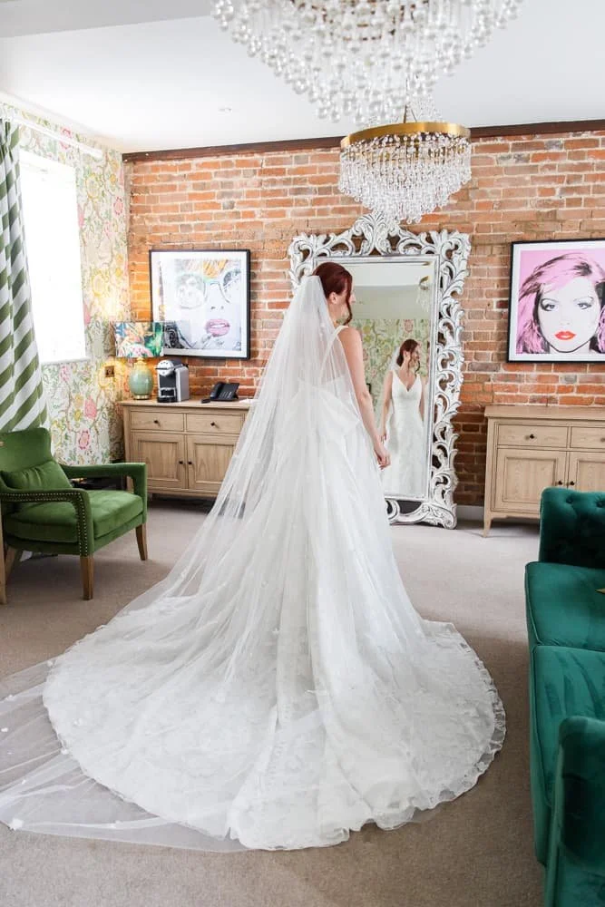 bride looking in mirror, all ready for her wedding