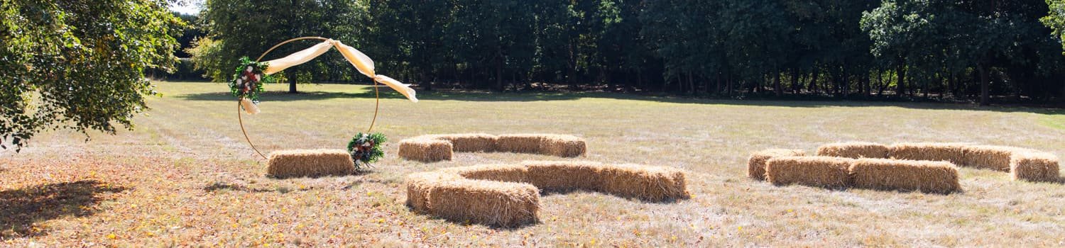 haybales as seating at diy wedding in field