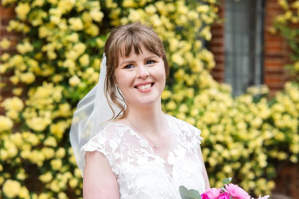 portrait of bride in front of yellow flowers