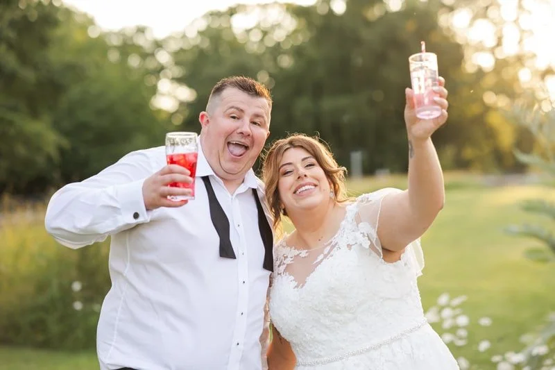 relaxed picture of bride and groom with drinks in the evening
