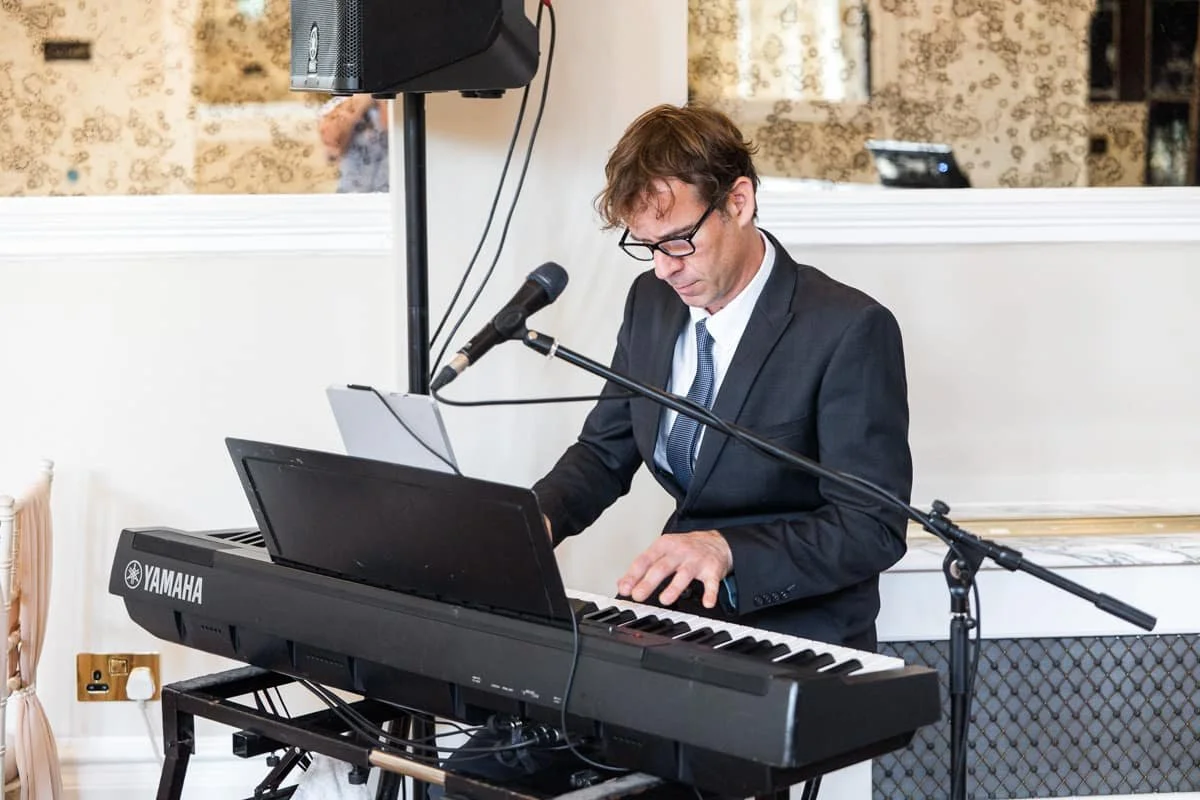 Live musician playing keyboard for the wedding ceremony at GreyFriars Colchester