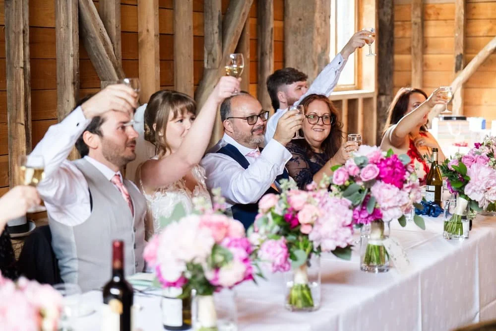 top table raising glasses at end of speeches