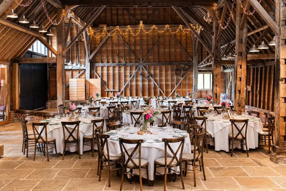 reception tables in barn at layer marney