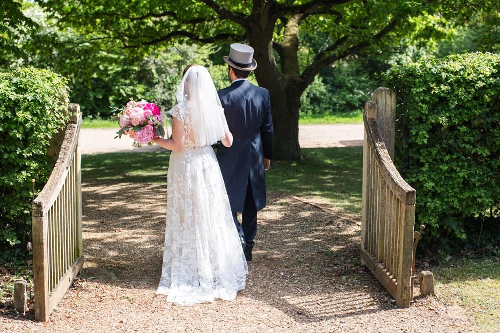 back of the bride and groom as they walk away
