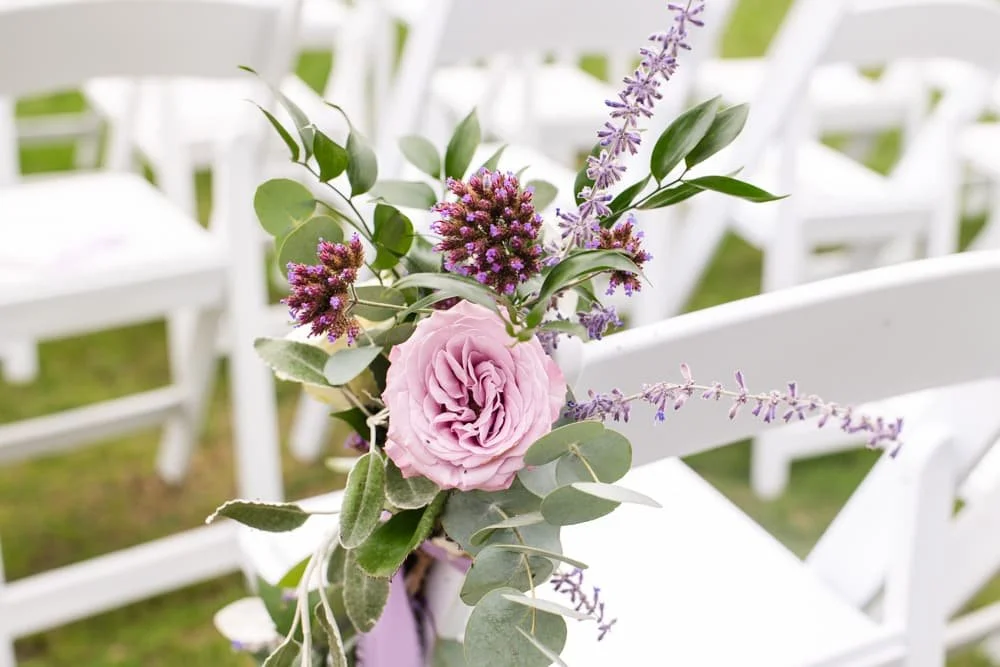 pink roses decorating the ceremony chairs