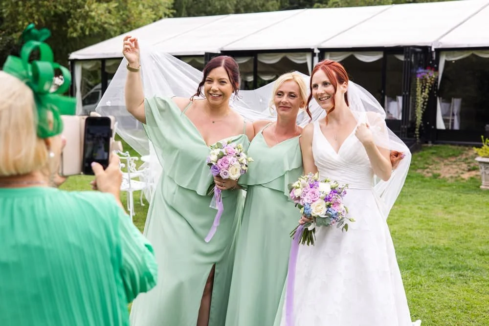 bridesmaids under brides veil