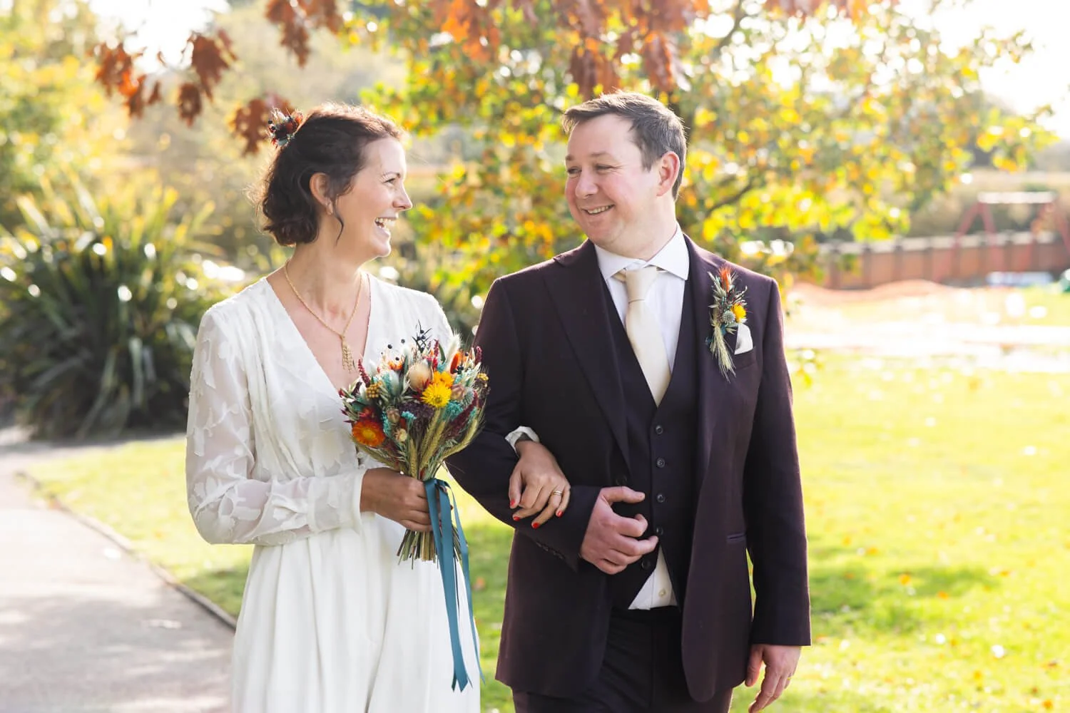 bride and groom walking in woodbridge public gardens on their wedding day