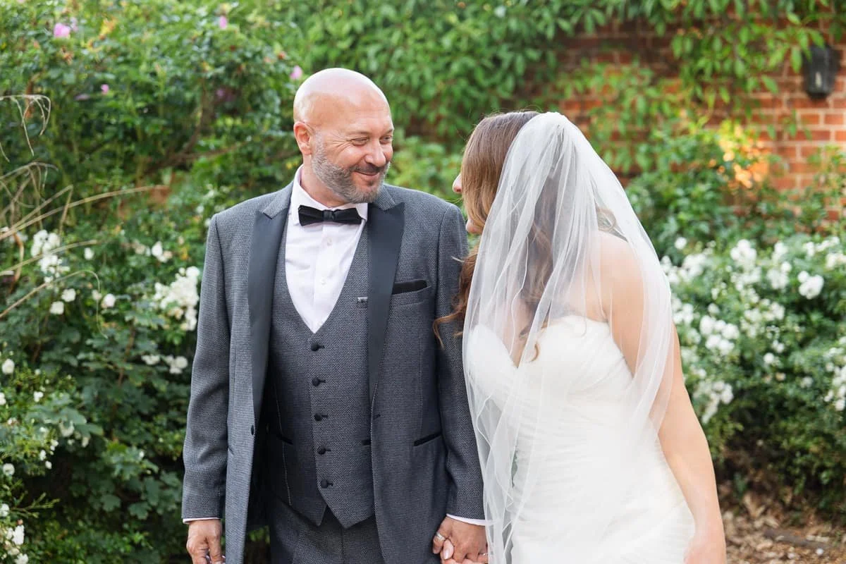 bride and groom walking and looking at each other