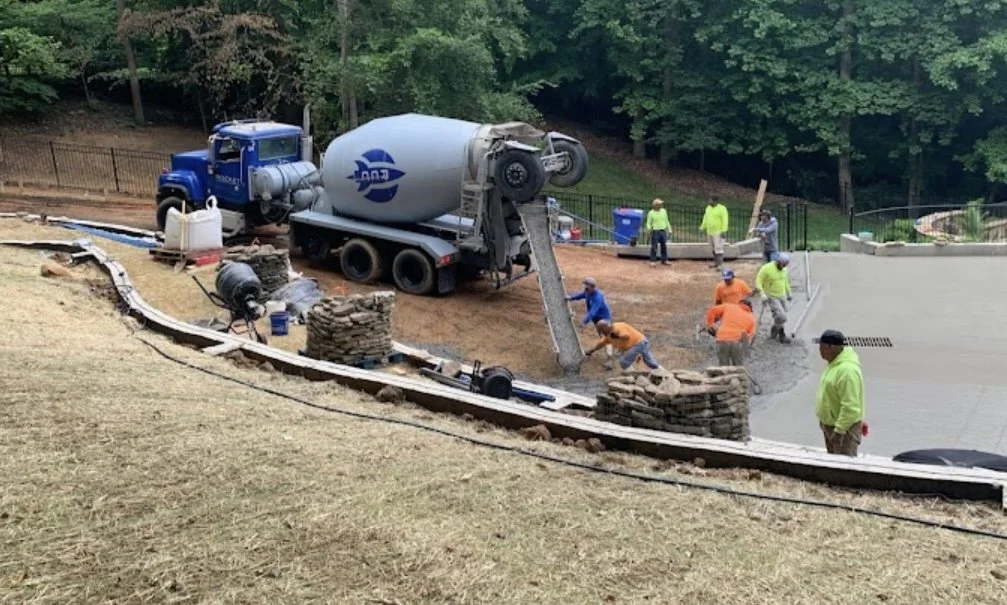Concrete contractors pouring a new driveway