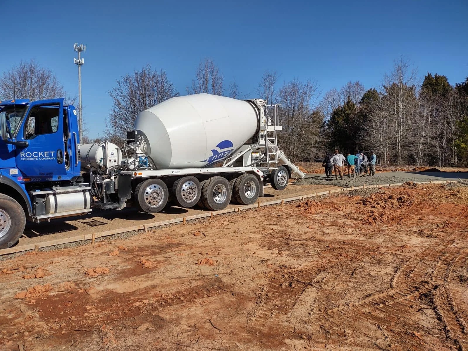 Concrete driveway installation with a concrete mixer truck on site