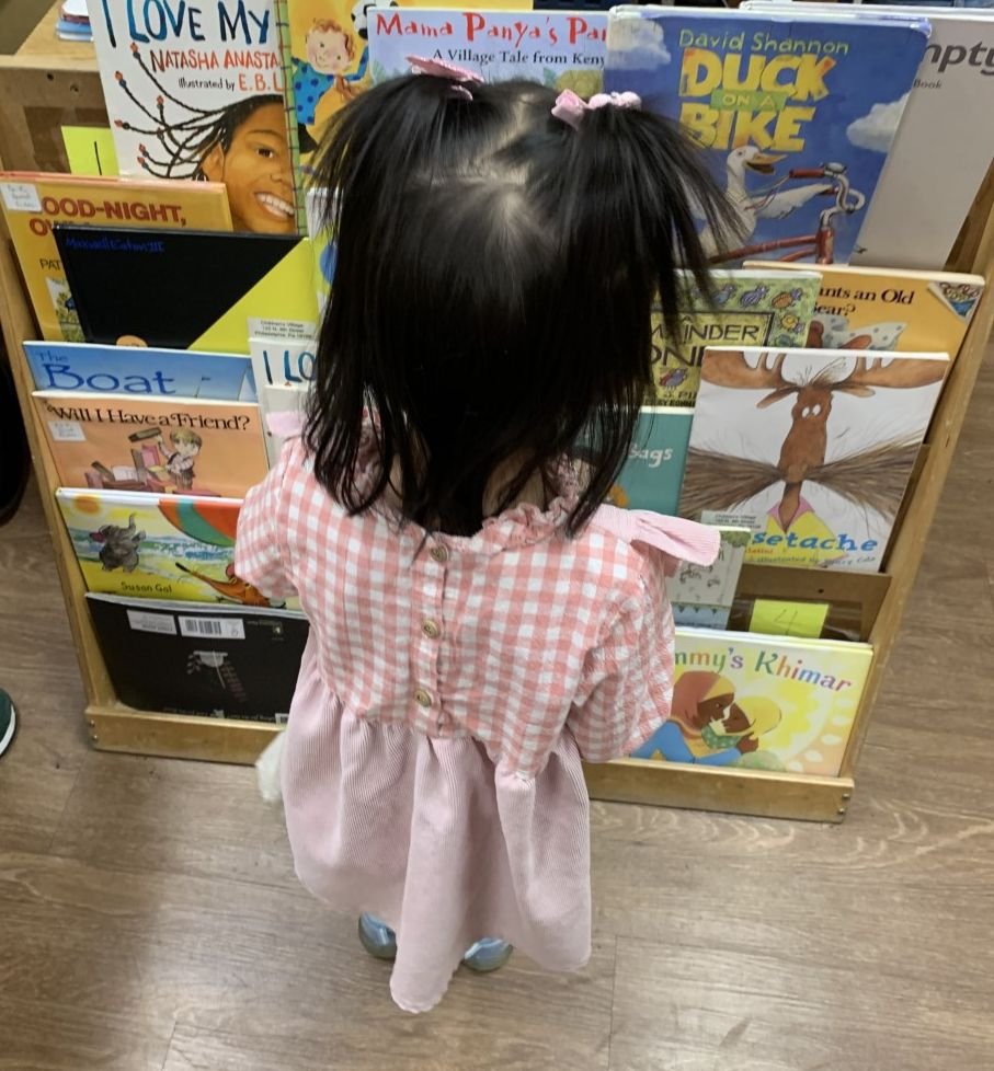 girl looking for a book from shelf.jpg