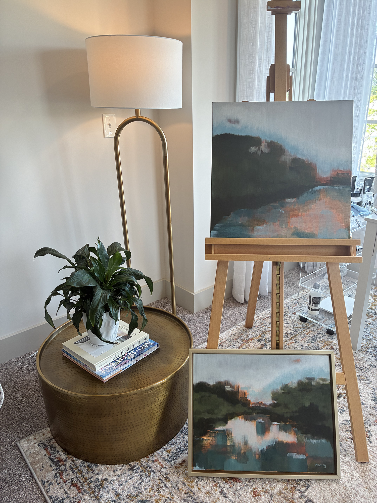 Original landscape on easel with brass accents
