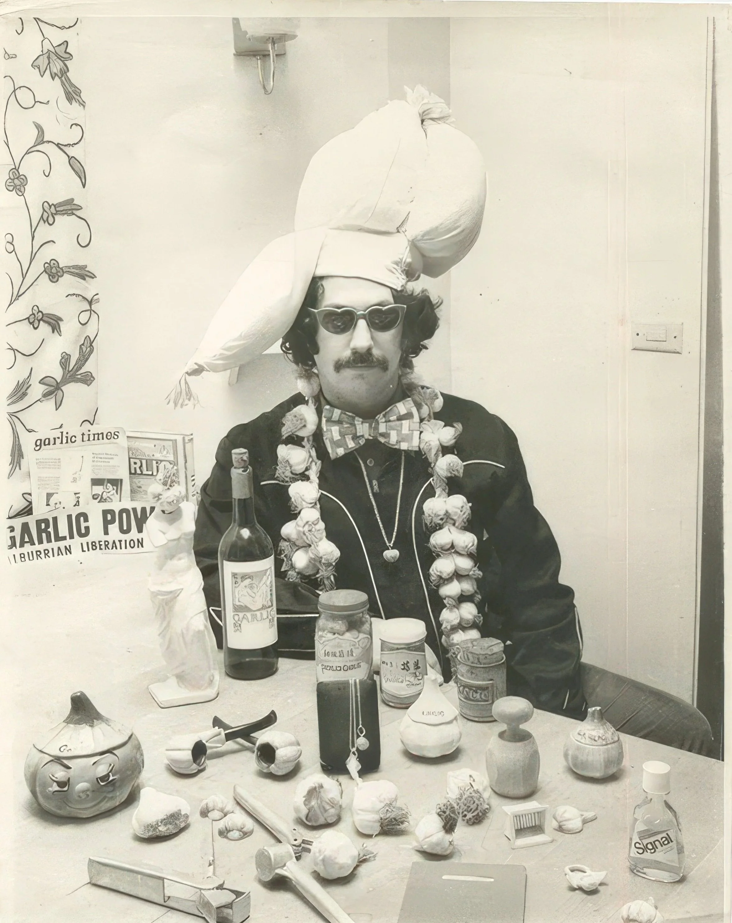 Wearing his ceremonial garlic turban and seated in front of his collection of garlicianna in the late ‘70s