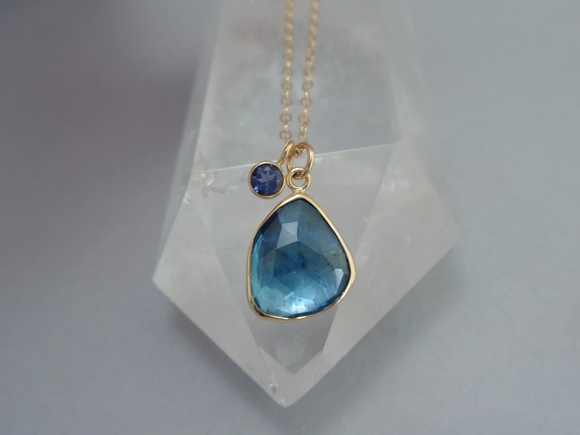 gold necklace with blue topaz and iolite x.jpg