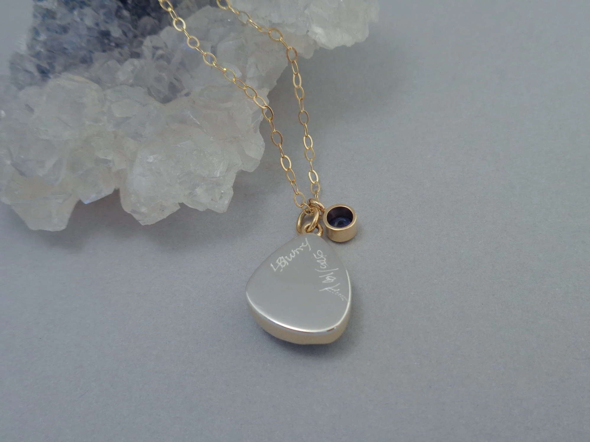 gold and silver pendant with blue topax and iolite x.jpg
