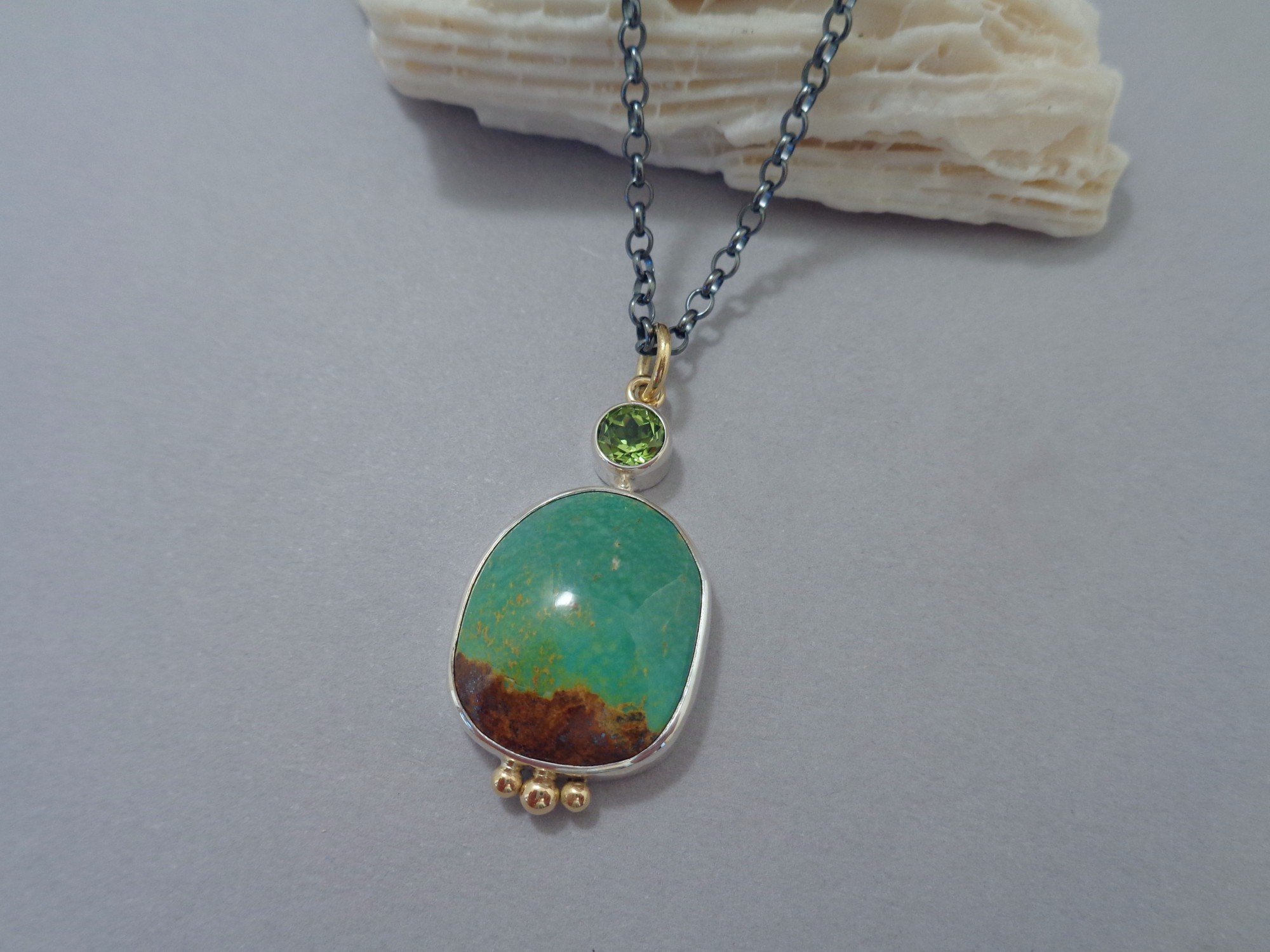 silver and gold pendant with turquoise x.jpg