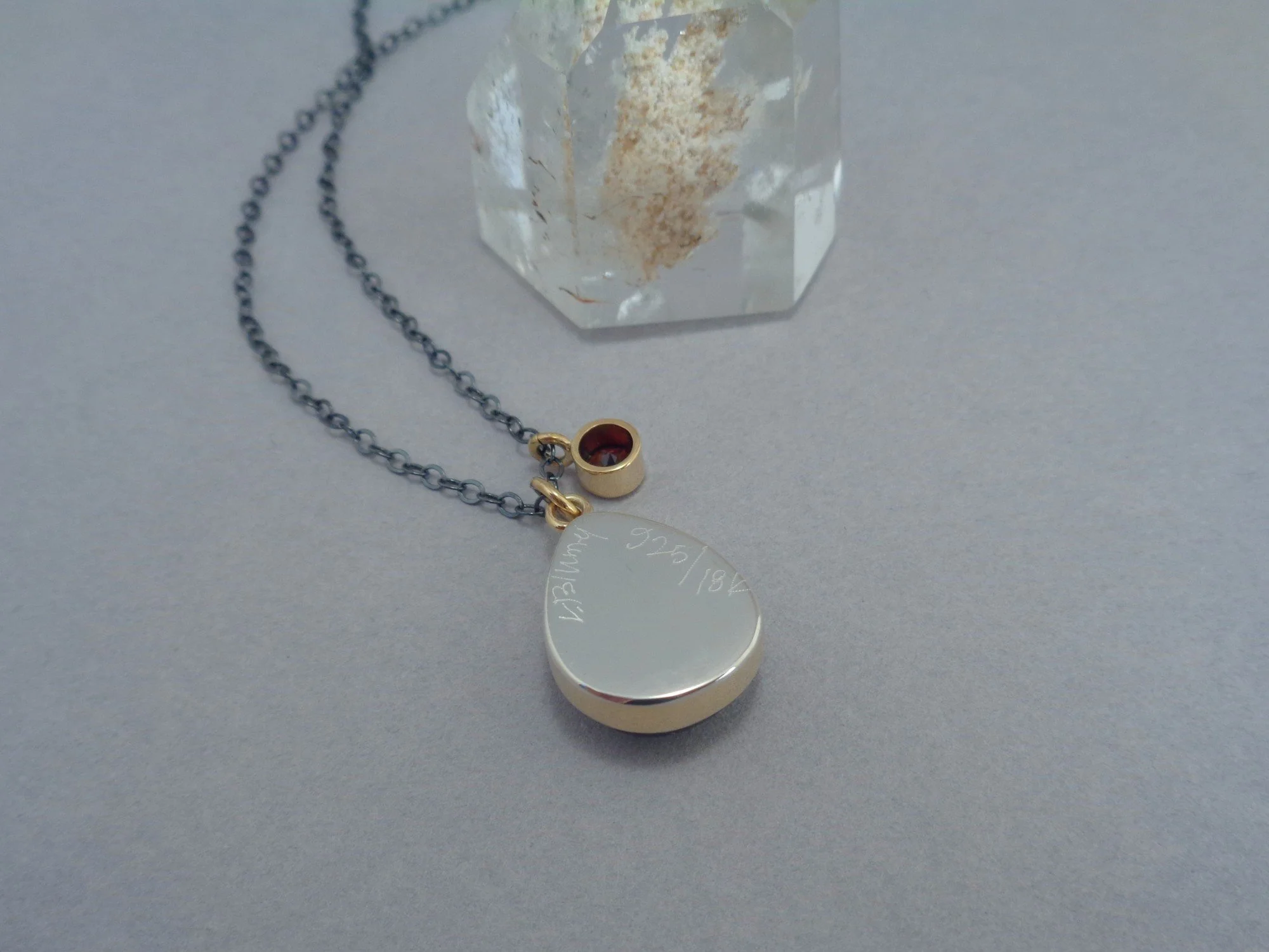 gold and silver pendant with red and pink stones x.jpg