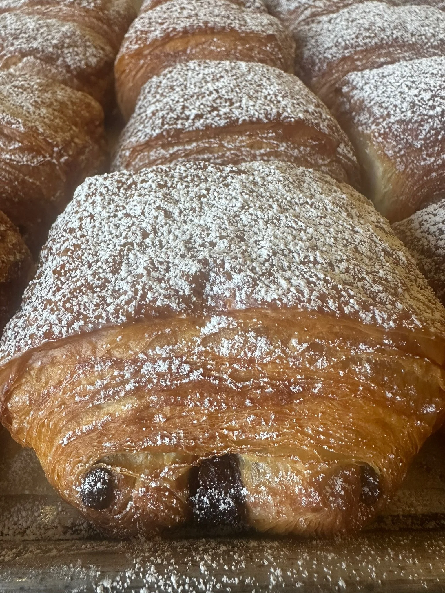 Pastry with powdered sugar and dried berries.