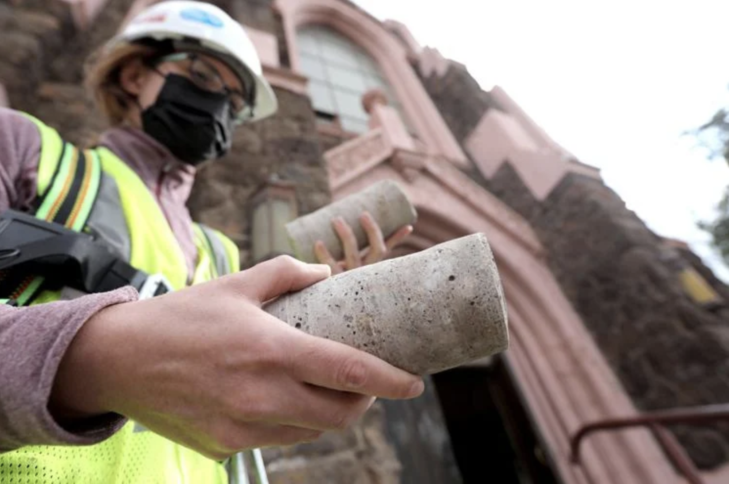  Engineer Marisa Turner holds concrete core samples drilled from the tower of the Nativity of the Blessed Virgin Mary chapel. The core samples will be studied to test the strength of the concrete holding up the tower.  Jake Bacon, Arizona Daily Sun 