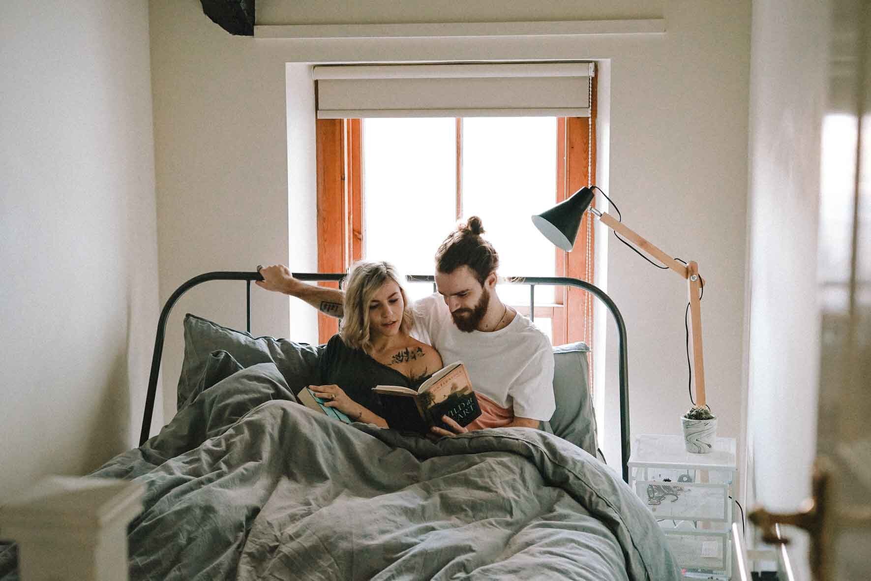 couple-enjoying-book-on-bed-importance-of-sex-in-a-relationship.jpg