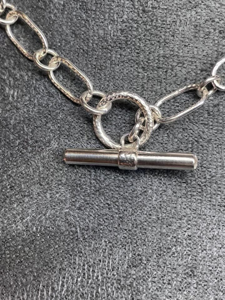 💫One of a kind piece looking for its forever home💫

A classic sterling silver toggle clasp necklace made entirely from handmade chain links. The fronts and backs of the paperclip style links have been textured to give a contrast of finish against t