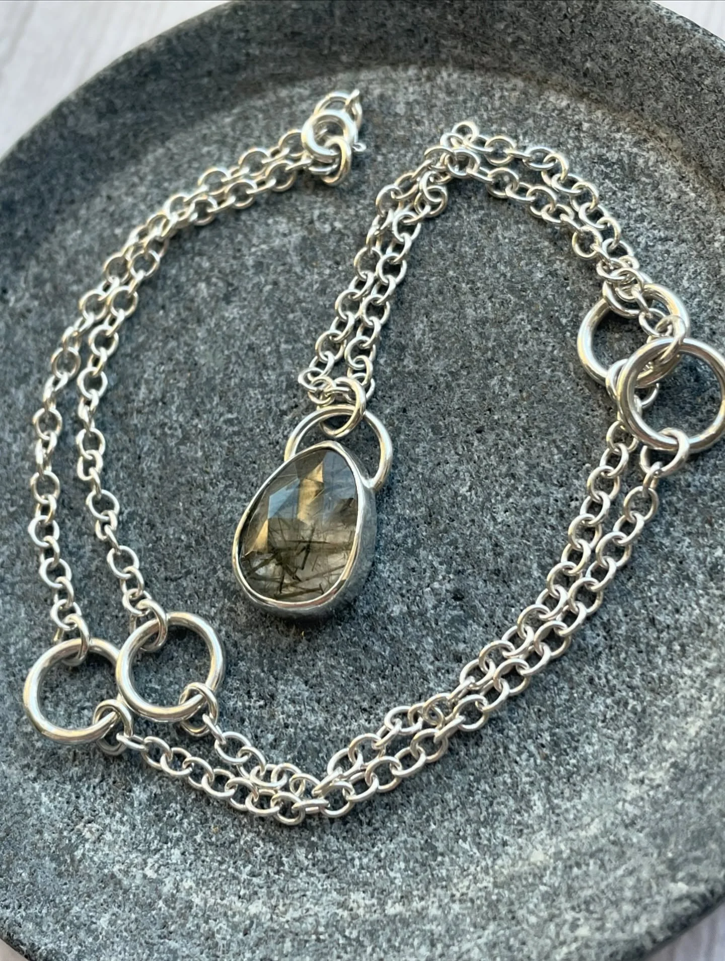 Just one of a few beautiful Rutilated Green Quartz necklaces available on the website. This one is suspended on an 18&rdquo; sterling silver chain with handmade circle details.

Each stone is unique with its needle like inclusions of titanium oxide (