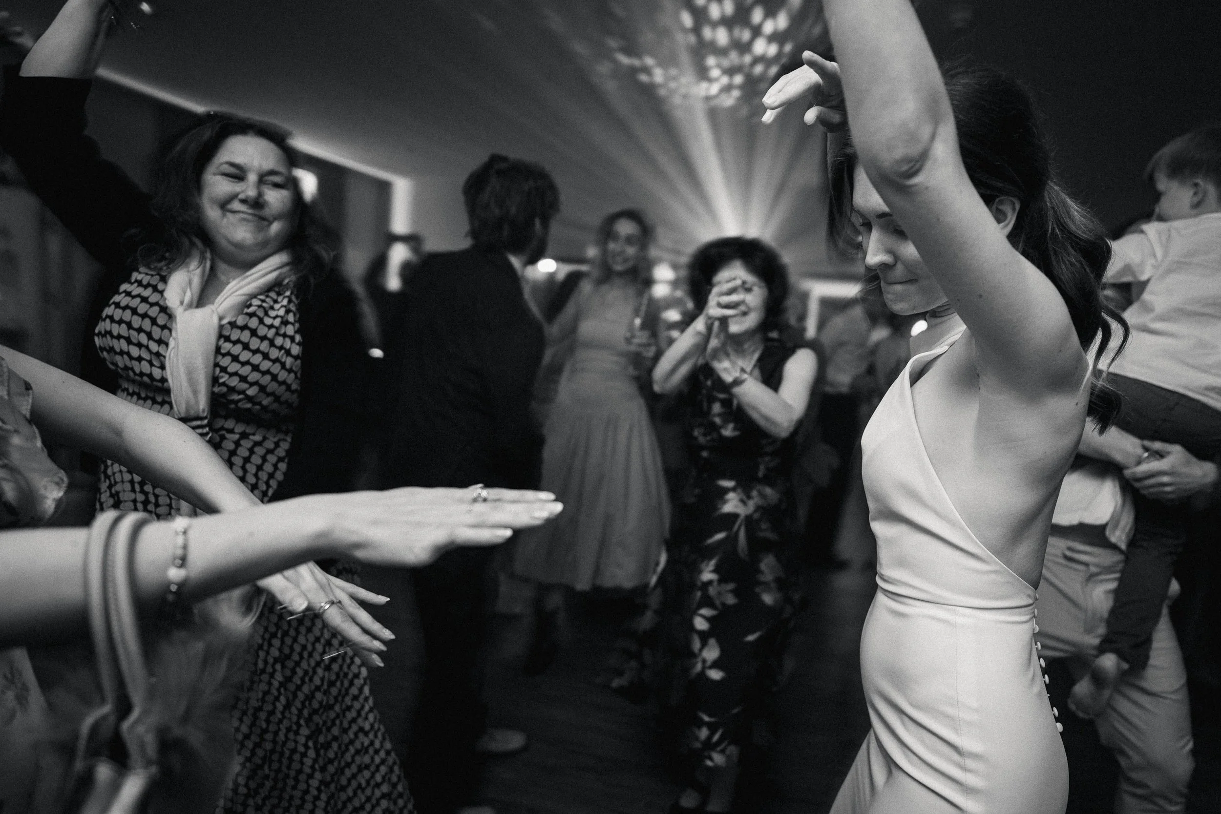 Black and white photo of bride dancing during the wedding reception at Two Woods Estate.